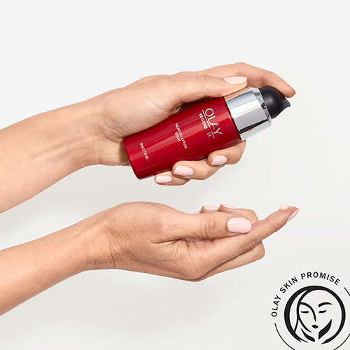 Model holding Micro-Sculpting Serum bottle in hand applying serum to other hand