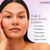 Model posing with applied Serum on face. 5 in 1 serum benefits to improve firmness, puffiness, tired eyes, fine lines, dark circles.