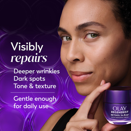 Model posing holding Olay Retinol24 Night Moisturizer jar. Visibly repairs deeper wrinkles, dark spots, tone and texture. Gentle enough for daily use
