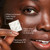 Model holding cleansing melt swatch close to face. Water activated daily facial cleanser. Deep clean without drying or stripping. Removes SPF, makeup and oil.