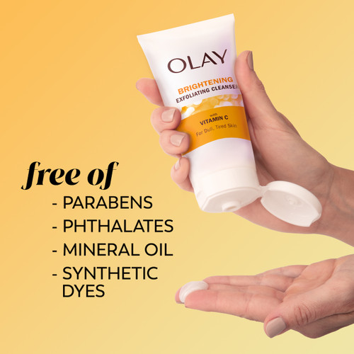 Vitamin C Brightening Cleanser bottle in hand squeezing cleanser onto fingers. Free of parabens, phthalates, mineral oil, synthetic dyes.