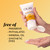 Vitamin C Brightening Cleanser bottle in hand squeezing cleanser onto fingers. Free of parabens, phthalates, mineral oil, synthetic dyes.