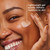 Model posing and smiling applying Olay Hyaluronic Ultralight Gel. Lightweight gel quickly delivers moisture to skin