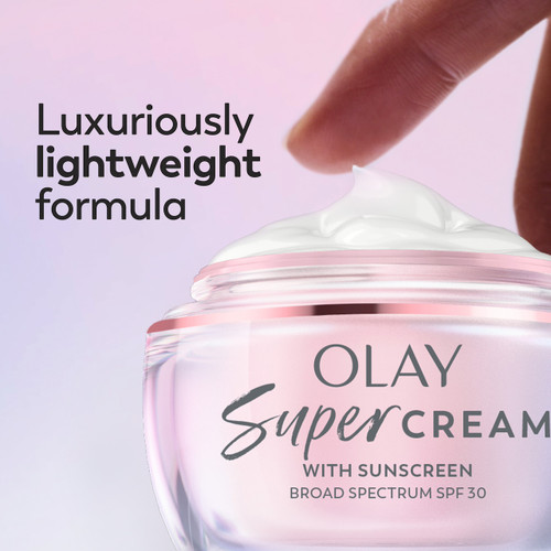 Model dabbing fingers in Olay Super Cream. Luxuriously lightweight formula