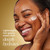 Model posing and smiling applying Collagen Peptide Moisturizing MAX Cream to face. Lightweight, non greasy cream that deeply hydrates.