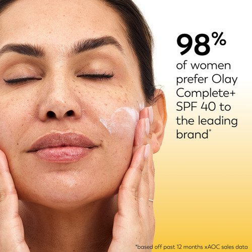 Model applying Olay Complete + Daily Facial Moisturizer with Sunscreen SPF 40 to face. 98% of women prefer Olay Complete + SPF50 to the leading brand* *based off past 12 months xAOC sales data