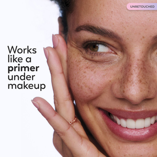 Model posing with hand on face. Works like a primer under makeup.