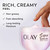 Model dipping fingers in Olay Super Serum Body Cream jar. Rich, creamy feel. Non-greasy, fast absorbing, long lasting moisture