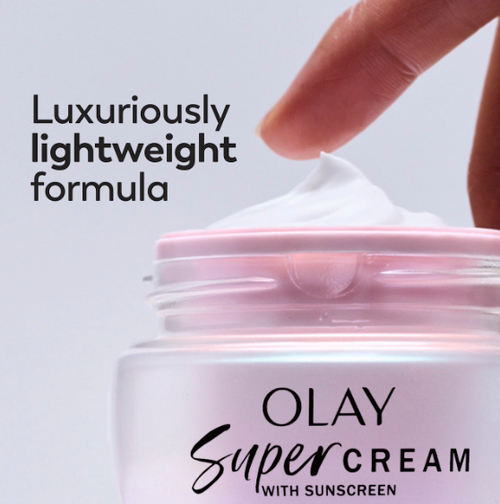 Model dabbing fingers in Olay Super Cream. Luxuriously lightweight formula