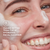 Model posing and smiling while applying melts cleanser to face. Cleans better than the #1 hydrating facial cleanser